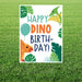 Colorful yard sign with "Happy Dino Birthday" text in teal and orange lettering, decorated with illustrated green dinosaurs, tropical leaves, a yellow flying pterodactyl, orange triceratops, teal balloon, and green foliage on white background.