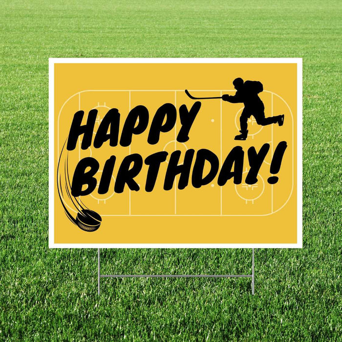 Yellow yard sign with white border featuring black text reading "Happy Birthday" and silhouettes of a hockey player and puck on a rink background.