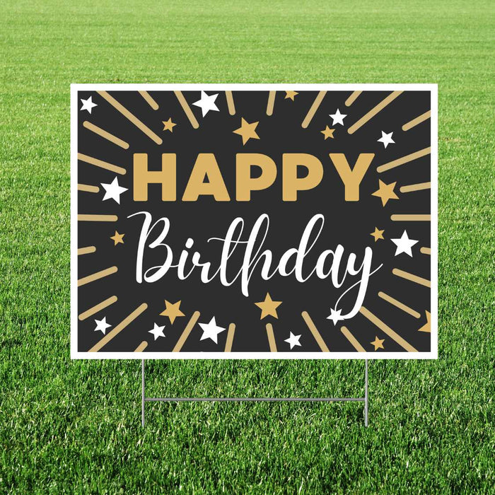 Black and gold yard sign with "Happy Birthday" text, radiating gold and white stars, and supporting stakes, displayed on grass.