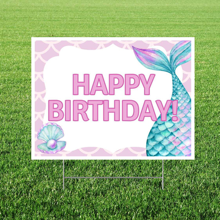 Mermaid-themed yard sign with pink "Happy Birthday" text, turquoise mermaid tail, seashell, and scalloped border on white background, mounted on metal stakes in grass.