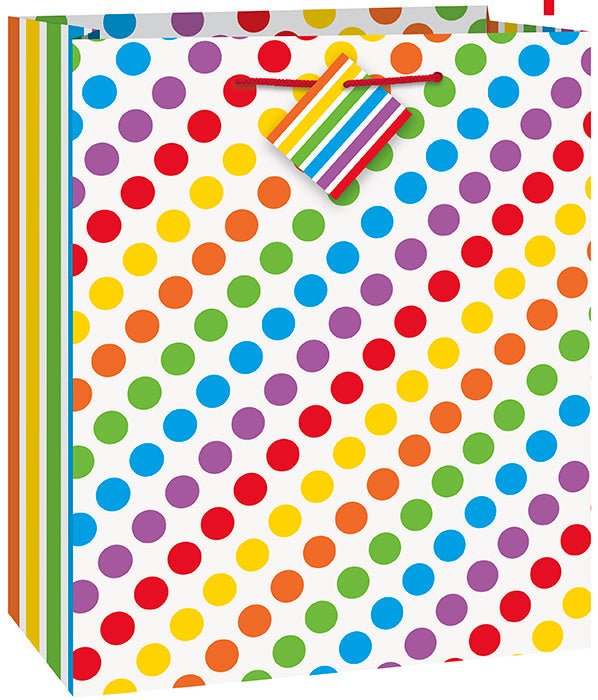 White gift bag with an all-over pattern of colorful polka dots in red, yellow, orange, green, blue, and purple, featuring rainbow-striped handles.