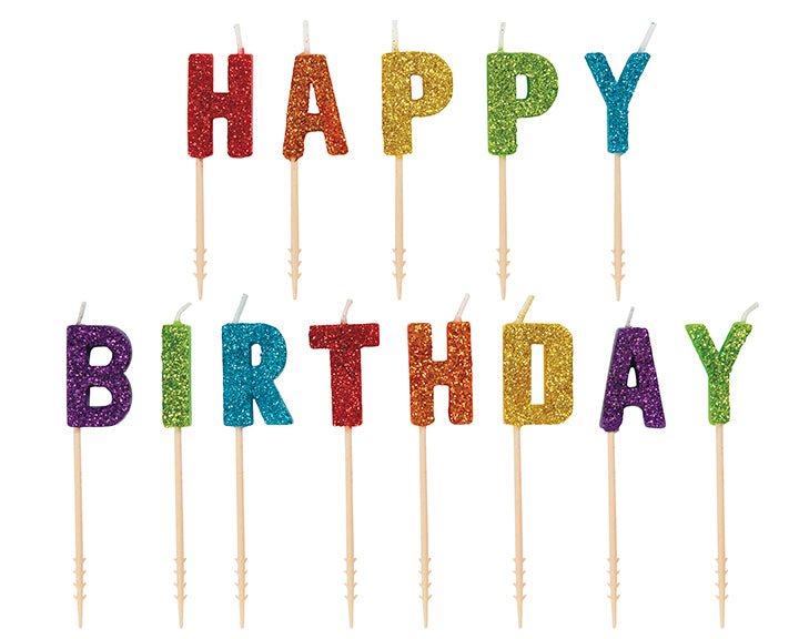Colorful glitter letter candles on wooden picks spelling "HAPPY BIRTHDAY" in red, orange, gold, green, teal, and purple.