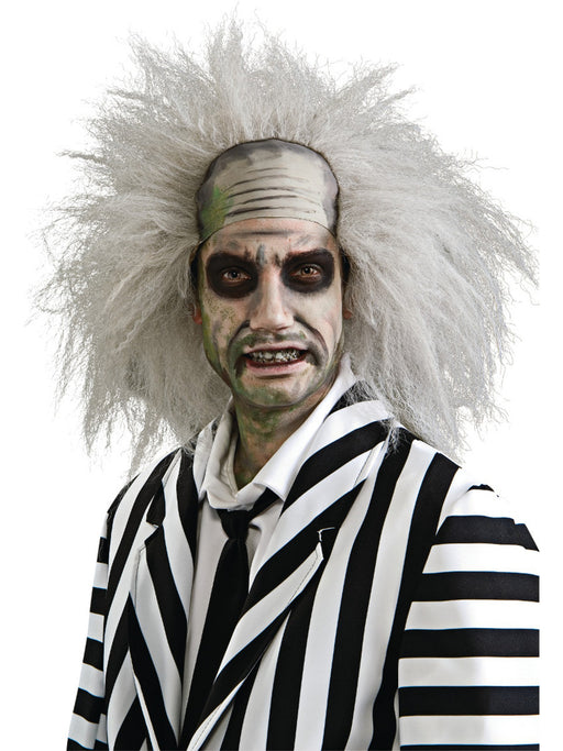 A man in a Beetlejuice costume wearing a Adult Beetlejuice Wig.