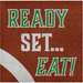 Orange football-textured napkin with green and white "Ready Set Eat" text and a white diagonal stripe detail.