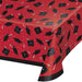 Red plastic tablecover with black graduation caps, tassels, and confetti pattern featuring a black border trim.