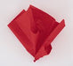 Crumpled red tissue paper shown in a pile against a white background.