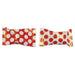 Two red and cream polka dot wrapped candies with twisted yellow and red foil ends displayed side by side.