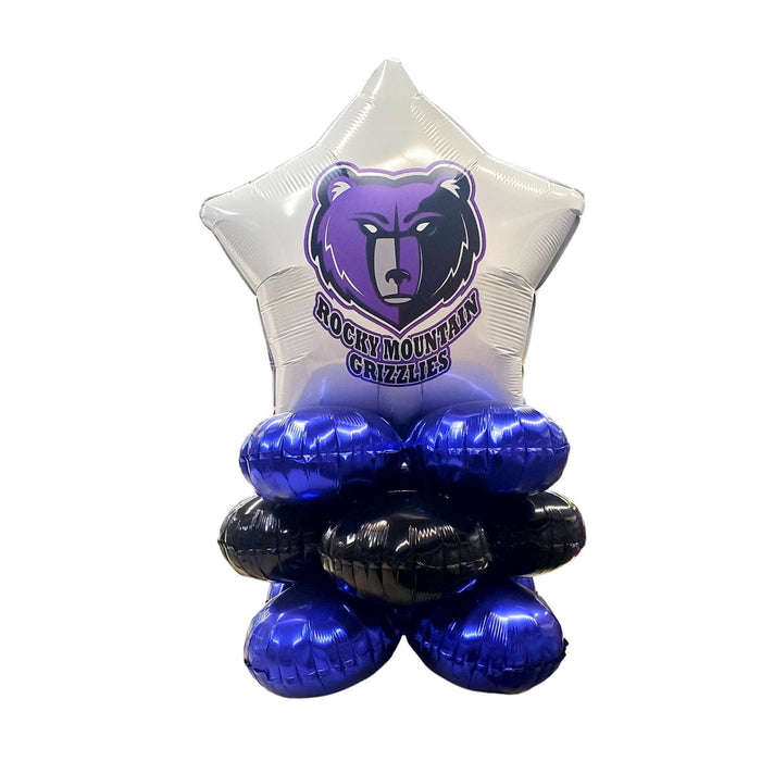 Silver star-shaped foil balloon with purple bear mascot logo and "Rocky Mountain Grizzlies" text, supported by blue and black air-filled balloon clusters at the base.