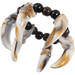 Beaded bracelet featuring four curved translucent animal tooth or claw pendants in cream and tan with black and brown spherical beads strung between them.