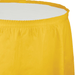 Bright yellow plastic tableskirt with gathered elastic top band and plain white interior panel shown against white background.