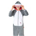 Child wearing a gray and white shark onesie costume with a red-lined mouth hood featuring white teeth and blue eyes.