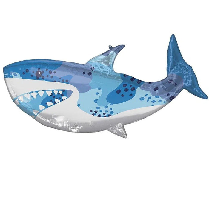 Blue and white mylar balloon shaped like a shark with teeth, spots, and a pointed dorsal fin against a white background.