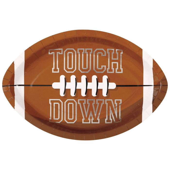 Brown football-shaped paper plate with white laces down the center and "TOUCH DOWN" text in white outlined letters.