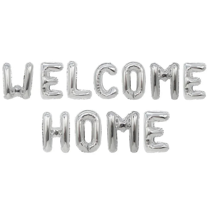 Silver foil letter balloons spelling "WELCOME HOME" arranged in two rows on a white background.