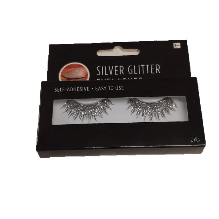 Black packaging box displaying a pair of silver glitter false eyelashes with self-adhesive backing, labeled "2 pcs" at the bottom.