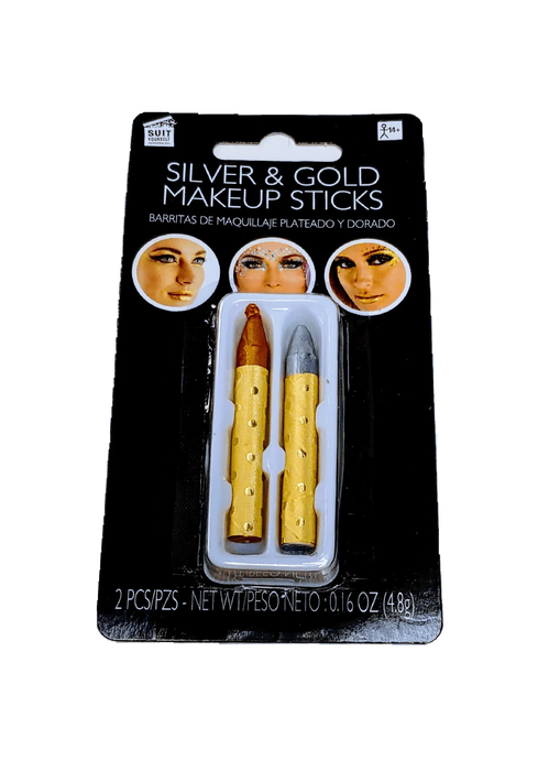 Package of two metallic makeup sticks with gold-textured wooden handles, one with red-gold tip and one with silver tip, displayed in clear plastic casing on black cardboard backing showing makeup application examples.