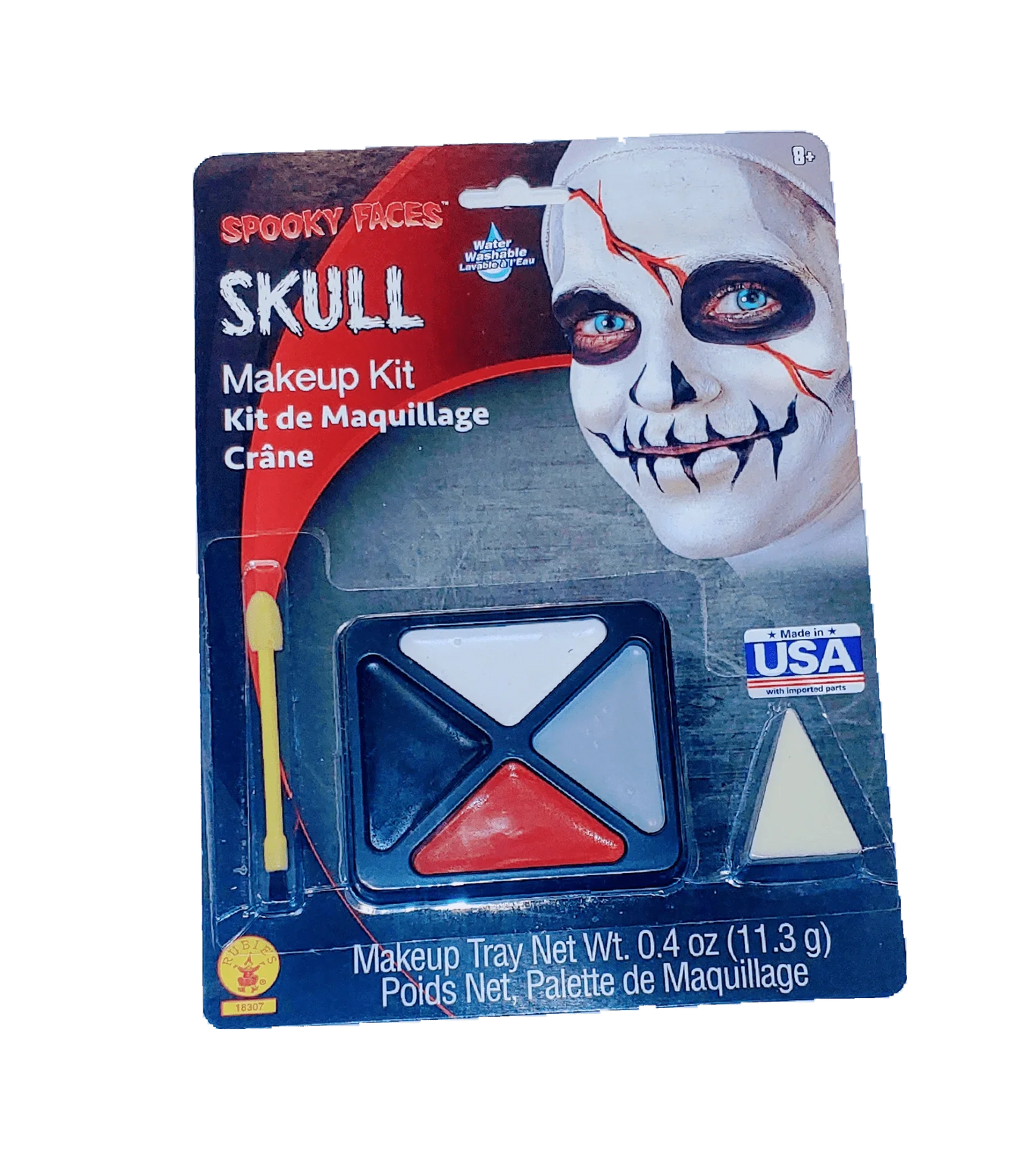 Spooky Faces Skull Makeup Kit package showing a skull-faced model with white and black face paint, red eye details, and a blue makeup palette with white, black, and red triangular sections plus a brush applicator.
