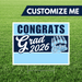 Graduation-themed sign with 'Congrats Grad 2026' on a grass background