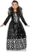 Child's black Gothic princess dress with long sleeves, ornate skull and crown print on skirt, sheer shoulder cape, and sparkle details throughout.