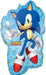 Blue mylar balloon shaped like Sonic the Hedgehog with his signature spiky hair, white gloves, red and white shoes, and a peace sign gesture, decorated with gold ring patterns on a light blue checkered background.
