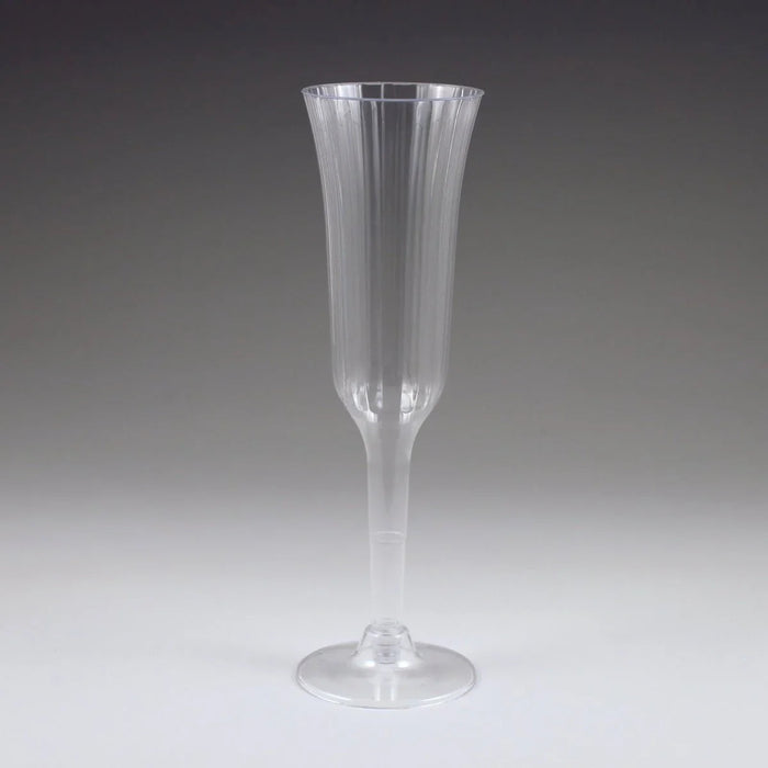 Clear plastic champagne flute with vertical ridged texture, tapered stem, and wide bowl, standing upright on a circular base against a neutral background.