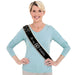Black fabric sash with gold studs and "It's my 60th Birthday" text in white, displayed on a woman wearing a light blue long-sleeved shirt.