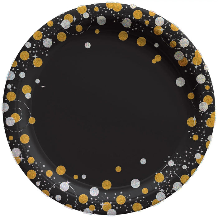 Black round paper plate with gold and silver glitter circles and white stars arranged in a decorative border pattern.