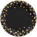 Black round paper plate with gold and silver glitter circles and white stars arranged in a decorative border pattern.