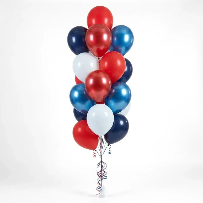Balloon bouquet featuring bright red, reflex red, navy, metallic blue, and white latex balloons with curling ribbons.