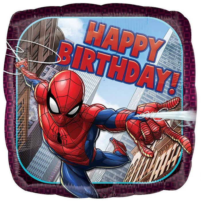 Square foil balloon featuring Spider-Man in red and blue costume swinging between city buildings with "HAPPY BIRTHDAY!" text in red letters against a blue sky background.