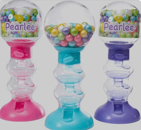 Three colorful gumball dispensers in pink, turquoise, and purple with clear globe tops filled with multicolored pearl-shaped candies and "Pearlee" branding visible on each.