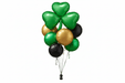 Festive balloon bouquet featuring three green heart-shaped balloons at the top, surrounded by green, gold, and black round balloons with silver ribbons and a black weight.