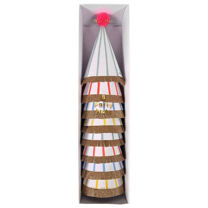 Stack of eight colorful striped party hats with gold glitter bands and a pink pom-pom on top, displayed in a tall rectangular box.