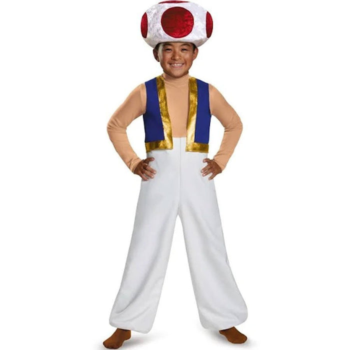 Child wearing a red and white spotted mushroom hat, blue and gold vest over tan sleeves, and white pants, posing with hands on hips.