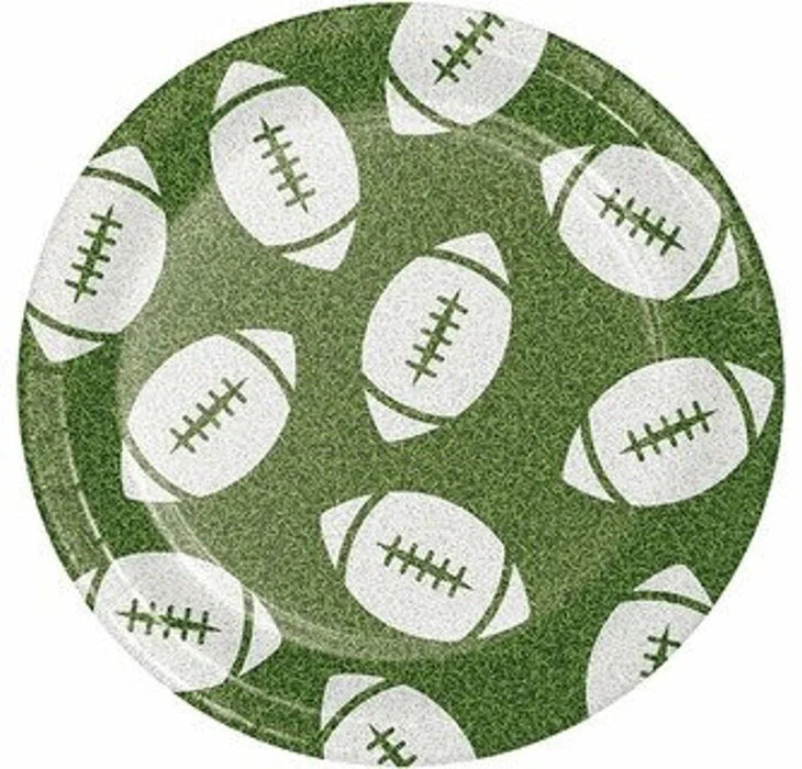 Green paper plates with white football designs and stitching details arranged in a repeating pattern across the surface.
