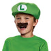 Child wearing a green cap with white L logo and attached brown mustache costume accessory set.