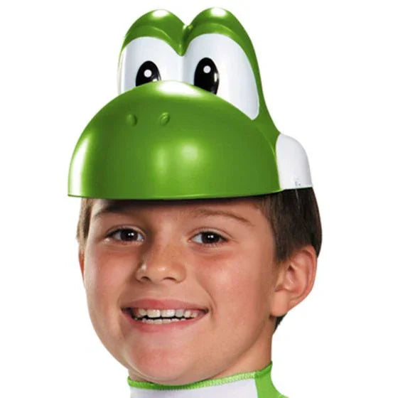 Child wearing a green and white Yoshi character headpiece costume hat with large expressive eyes and an open mouth design.
