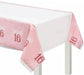 Pink tablecloth with "Sweet 16" text and glittery borders draped over a white table.