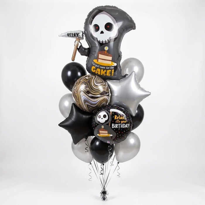 Chill to the Bone Birthday Balloon Bouquet with grim reaper foil balloon, birthday foil balloon, black and silver star balloons, marbled balloon, and black and silver latex balloons.
