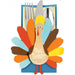 Colorful paper turkey-shaped utensil holder with "Give Thanks" text, featuring a cream body, yellow head, red beak, and multicolored feathers in orange, red, yellow, blue, and brown, holding a fork, knife, and spoon against a blue background.