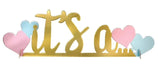 Gold foil "it's a" text centerpiece decoration with pink and blue heart cutouts on either side.