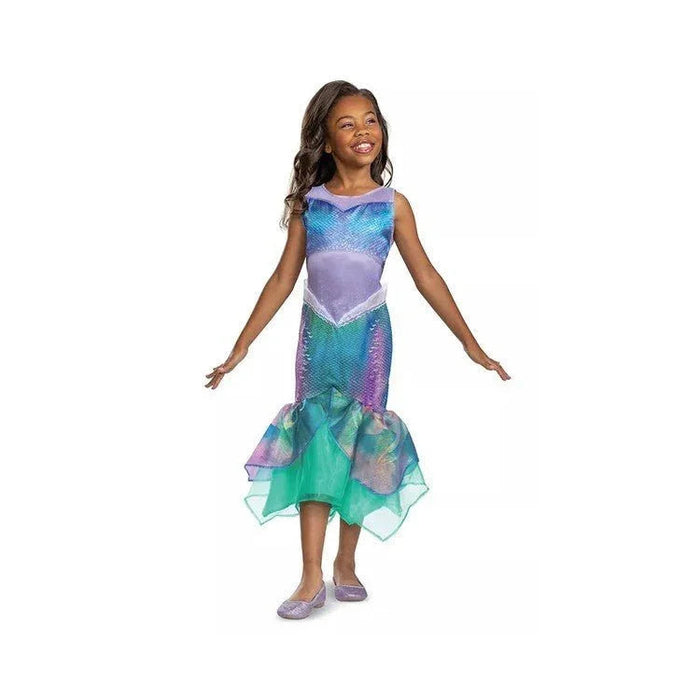 Child wearing a purple and teal mermaid costume with sequined bodice, sheer overlay, and asymmetrical handkerchief hemline, paired with matching purple shoes.
