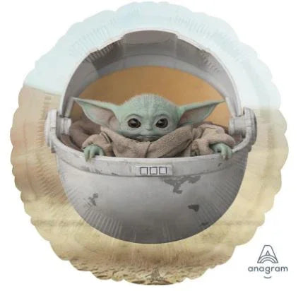 Round foil balloon featuring Baby Yoda character in a hovering spacecraft pod, with cream and light blue coloring and an Anagram logo visible.