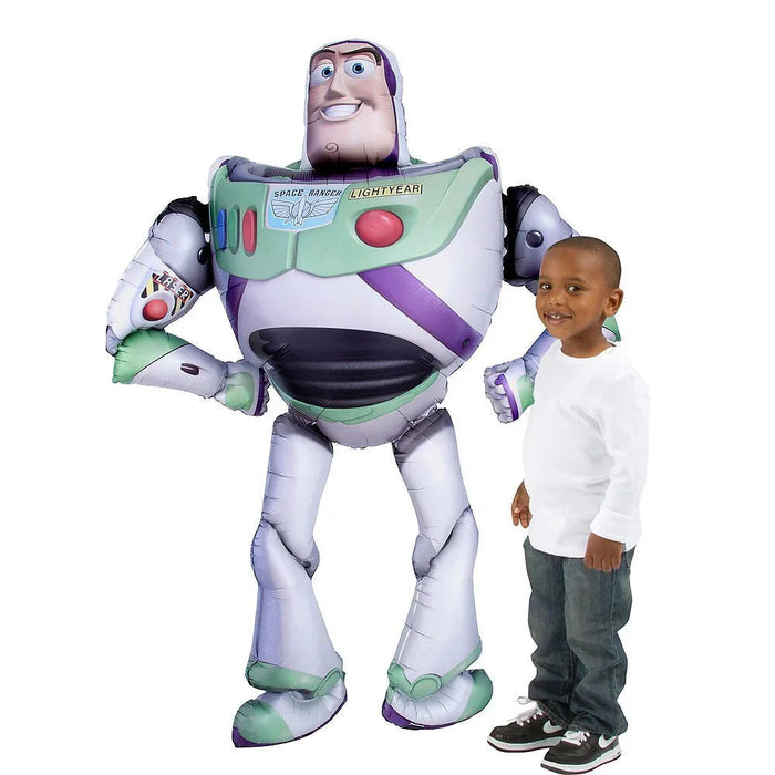 Oversized inflatable Buzz Lightyear character balloon in white, purple, and green with "Space Ranger Lightyear" text on chest, standing next to a smiling child for scale.