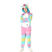 Child wearing a colorful rainbow unicorn onesie costume with a hooded unicorn head featuring a gold horn, pink mane, and large eye, paired with white socks and shoes.