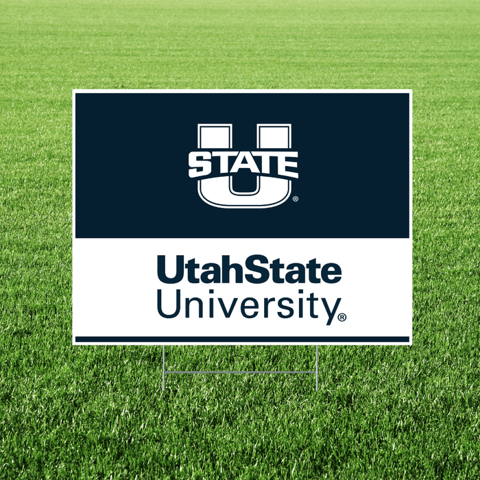 Utah State University sign on a grass background