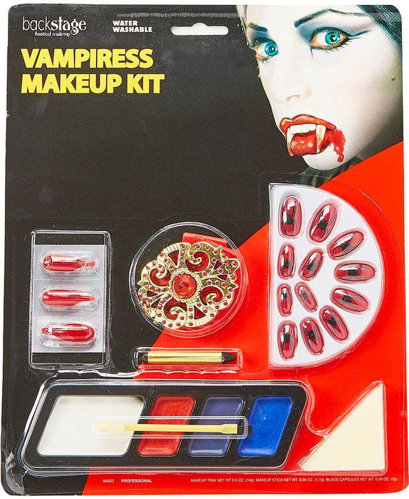 Backstage Vampiress Makeup Kit featuring fangs, nail appliques, red and black face paints, eyeshadow palette, and applicator brushes on red and black packaging.