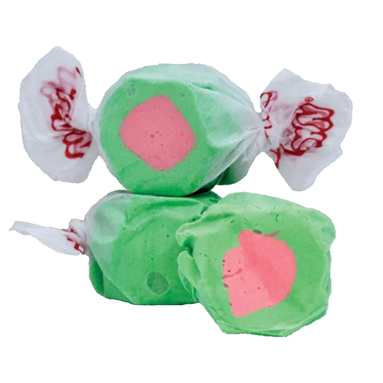 Three green and pink salt water taffy candies with white wrapper ends featuring red text, arranged in a pile to resemble watermelons.