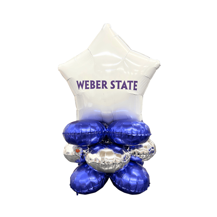 White star-shaped foil balloon with "Weber State" text in purple, positioned above a cluster of four blue and silver round foil balloons arranged as a decorative balloon bouquet.