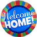 Round blue mylar balloon with "Welcome Home!" in white text, surrounded by a colorful striped border in red, green, orange, and blue with a navy band of stars.